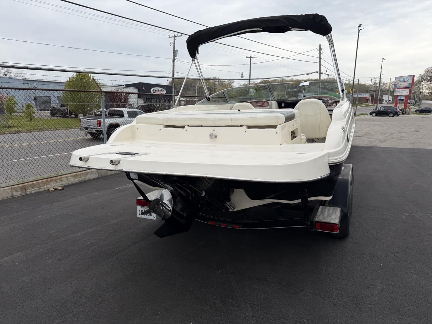Pontoon boat on trailer at Hall's Sport Center for sale or rent.
