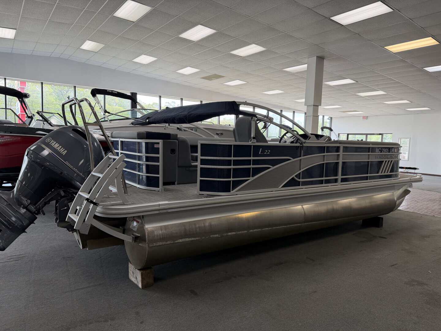 Pontoon boat with Yamaha outboard motor, ideal for recreational boating and water activities at Hall.