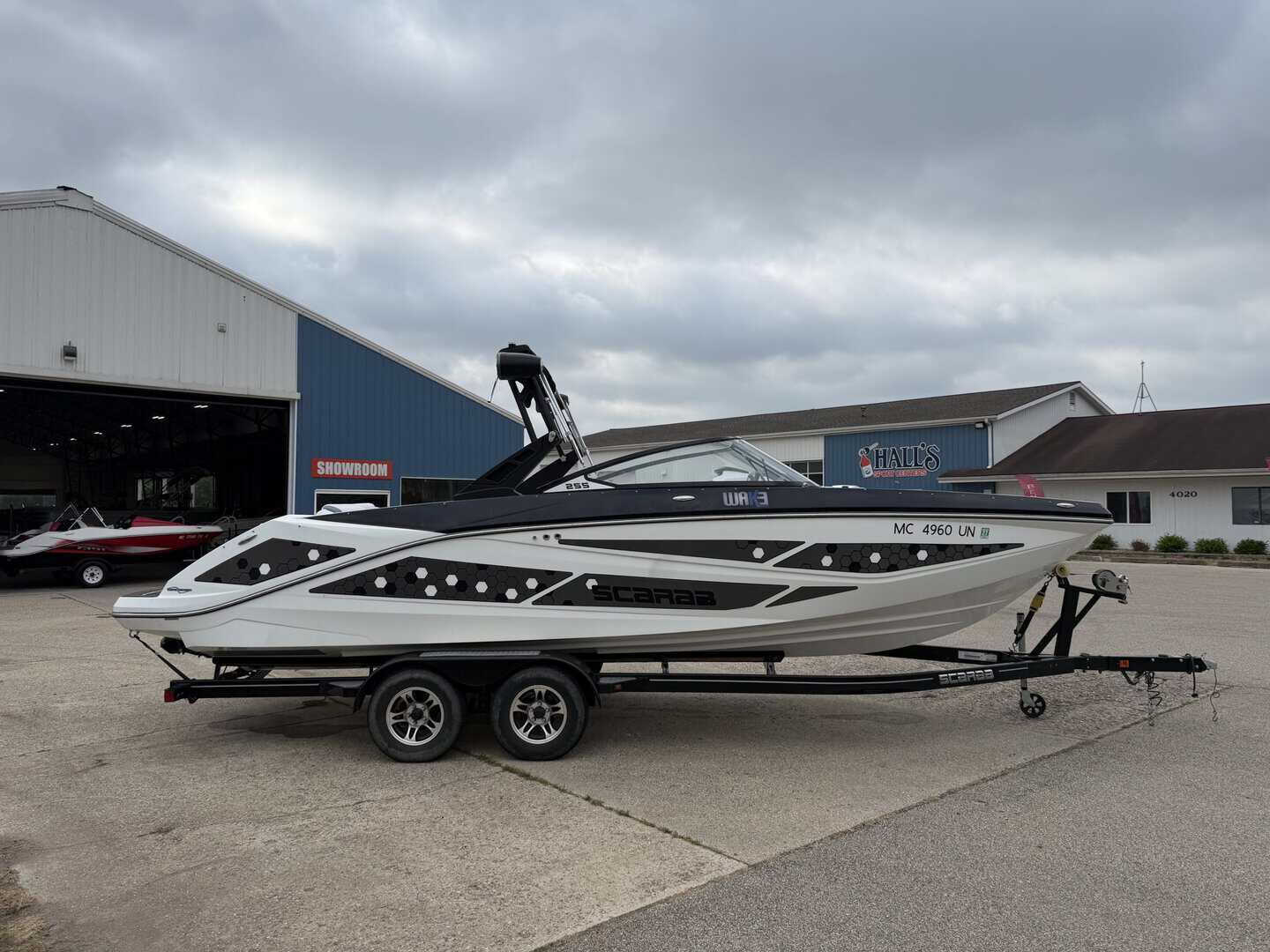 2021 Scarab 255ID speedboat on trailer outside Hall's Sport Center.
